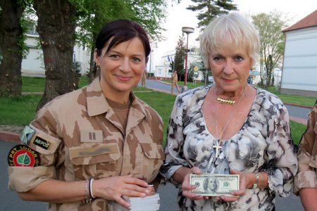 Bela Gran Jensen (right) hands over the financial gift to a CIMIC member of 10th Unit of PRT Logar advance party to be used in favour of children in Afghanistan