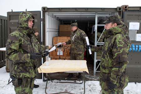 Warrant Officer Tomas Vachal describes the way of dispensing gas masks to Major Ladislav Horak, commander of the organisational core