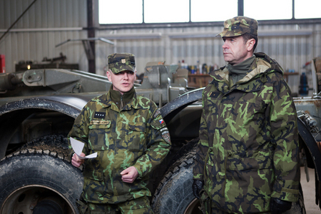 Staff Sergeant Roman Doupnik, leader of a repair squad, explains activities in handling with wheeled vehicles