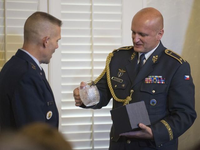 Brig. Gen. Libor Stefanik of Czech Republic presenting Lt. Gen. Steven L. Kwast with a crystal mug after Gen. Stefanik's induction into the International Honor Roll during a ceremony that inducted 24 new members on Wednesday, Dec. 3, 2014 at Maxwell Air Force Base in Montgomery, Ala.