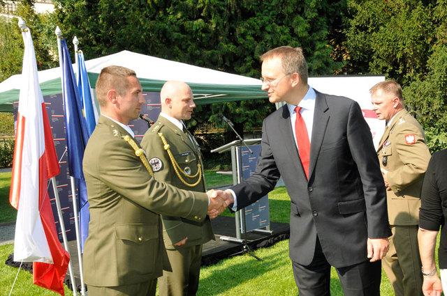 Daniel Kostoval congratulating Captain Rostas on receiving the award