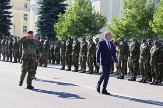 Defence Minister Lubomír Metnar reviews the unit lined up in Prostějov