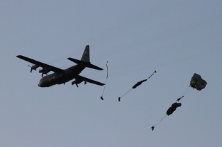 Air drop of materiel is followed by a mass paratroopers drop