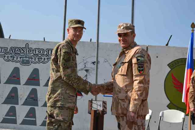 Commander of the 438 Air Expeditionary Advisory Wing Colonel LeRoy congratulates the outgoing commander of the 438th Air Expeditionary Advisory Squadron, Lieutenant Colonel Vladimir V., and presents the US military medal