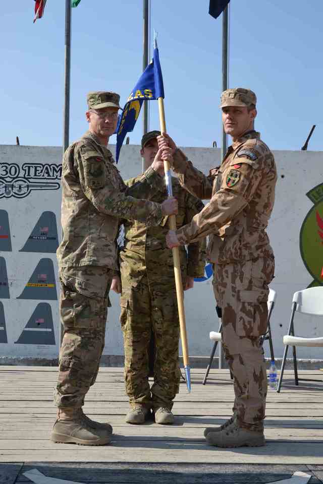 Major Radek M. taking over the flag of the 311th Air Expeditionary Advisory Squadron (former 438 AEAS)