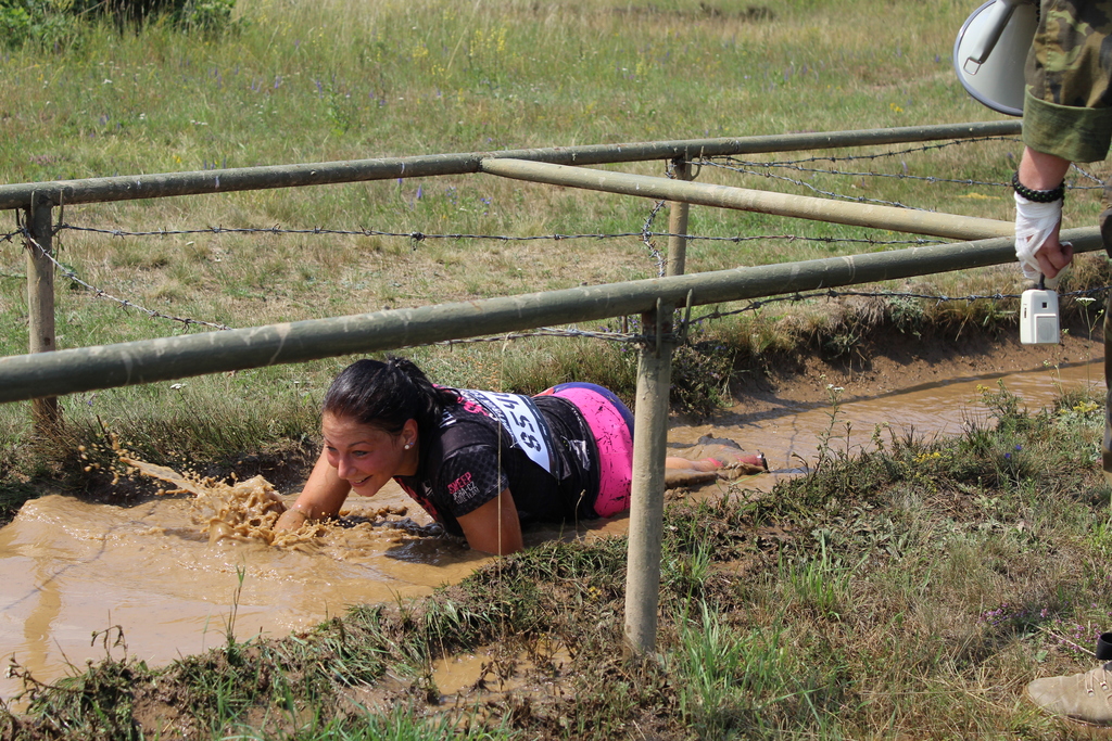 The look of "enjoyment" of a participant under the barbed wire