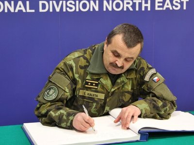 Genmjr. Štefan Kaleta se podepisuje do pamětní knihy mnohonárodní divize
