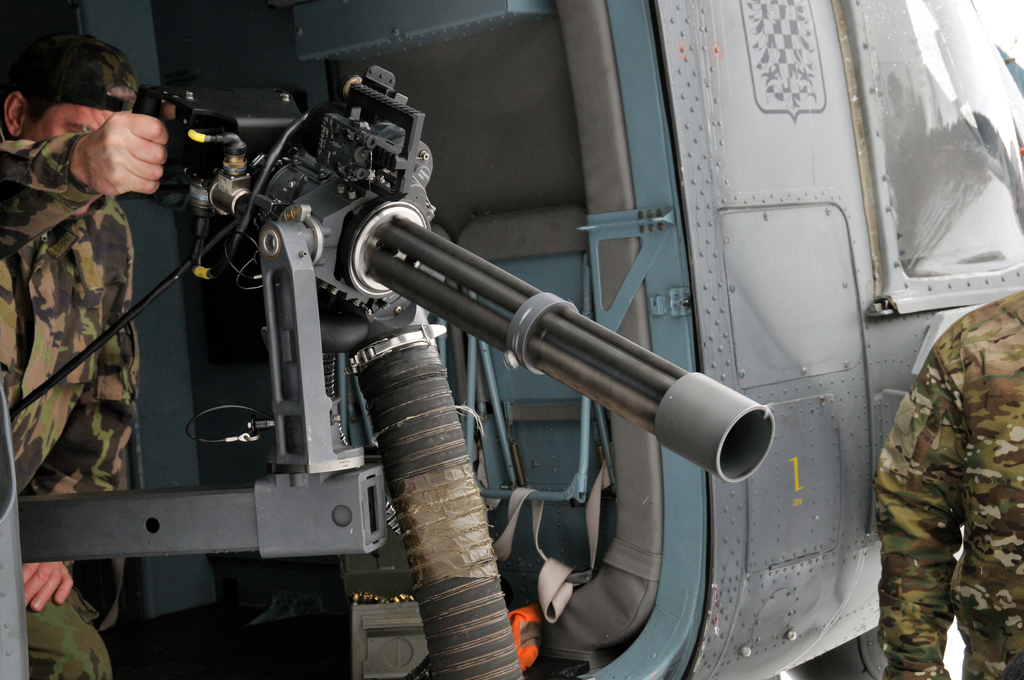 A gunsmith checking his gun before take off