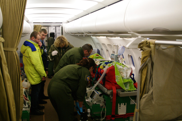 Lékařský personál připojuje pacienta na přístroje jednotky PTU na palubě letounu Airbus