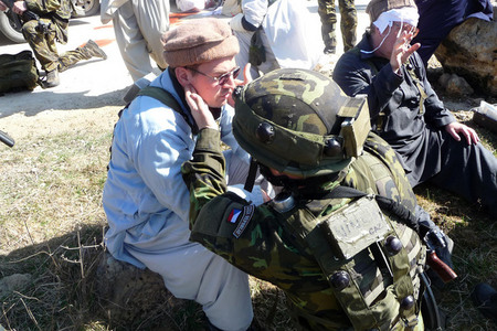 Soldiers give first aid after a road accident