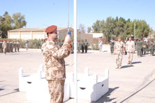Major Kana (commander of the first Czech unit of the 1st CAF Contingent) hoists the Czech flag at the MFO ceremony